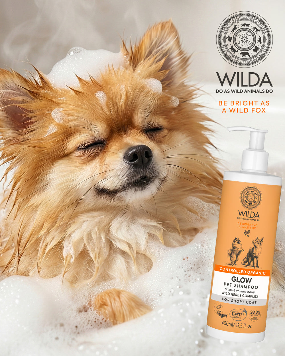 Dog in bubbles with a bottle of Wilda pet shampoo